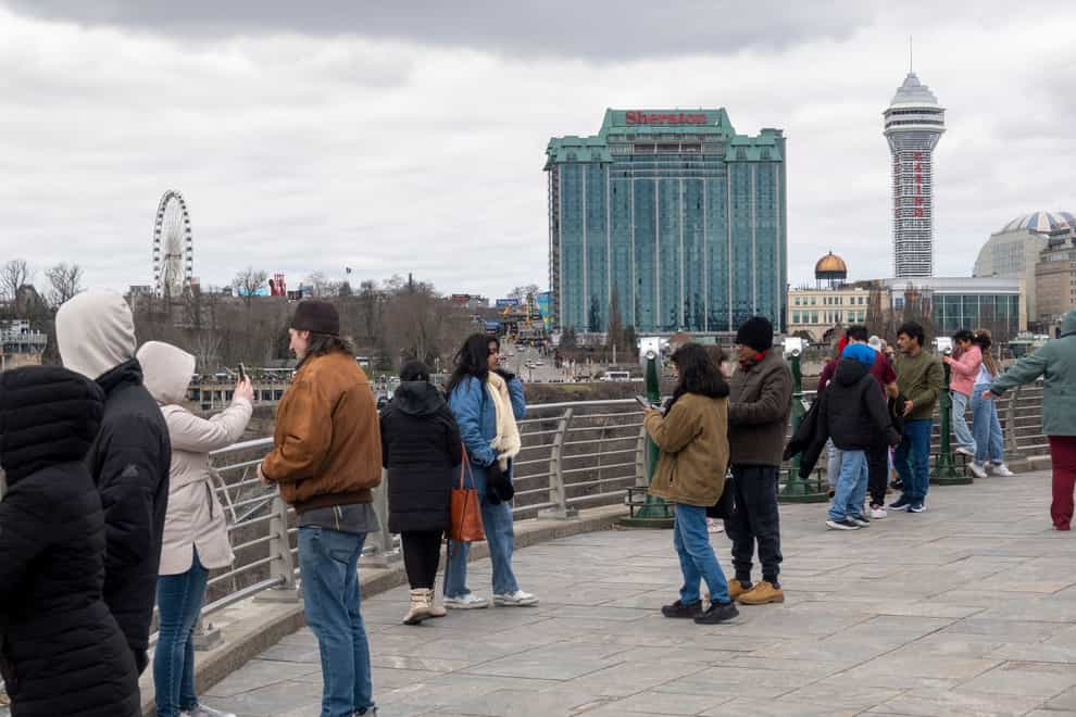 Tourists on the American side of Niagara Falls take photos (Carlos Osorio/The Canadian Press via AP)