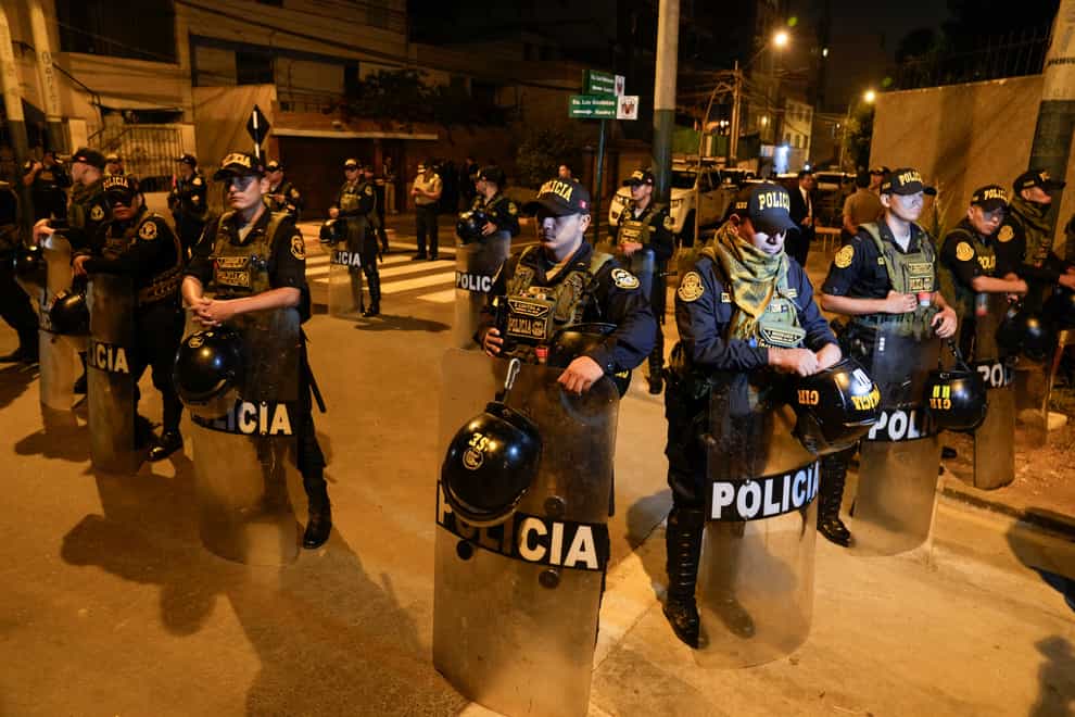 Police stand guard outside President Dina Boluarte’s residence (Martin Mejia/AP)