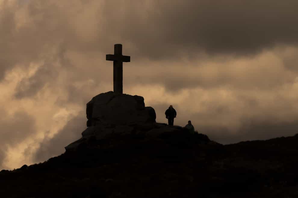 Walkers near the Rylstone Cross on Barden Moor, North Yorkshire on Good Friday (PA)