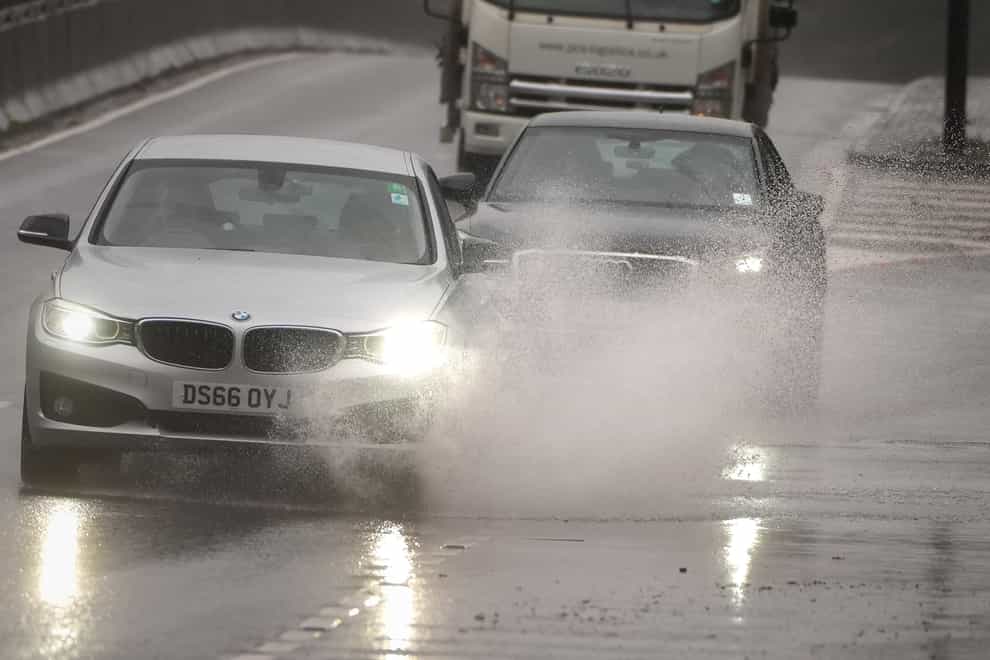 Cars drive through the rain on the A3 (Aaron Chown/PA)