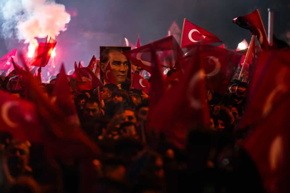 Supporters of Istanbul Mayor and Republican People’s Party candidate Ekrem Imamoglu celebrate outside the City Hall in Istanbul (Khalil Hamra/AP)