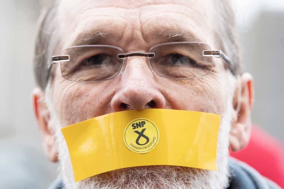 A campaigner tapes his mouth shut in opposition to new hate speech legislation in Scotland (Lesley Martin/PA)