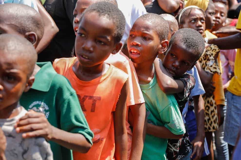 Children line up to receive food at a shelter for families displaced by gang violence, in Port-au-Prince, Haiti (Odelyn Joseph/AP)