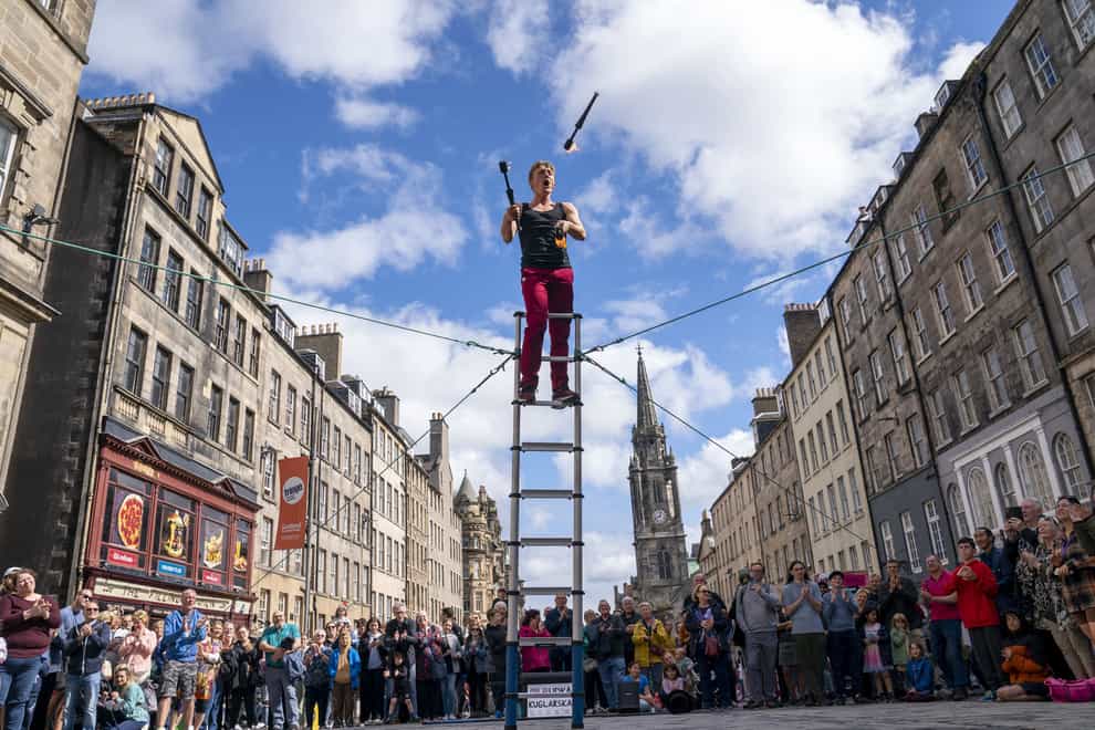 Street performers entertain the crowds on Edinburgh’s Royal Mile at Edinburgh Festival Fringe (Jane Barlow/PA)