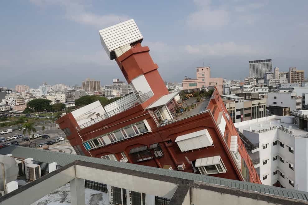 A partially collapsed building stands at a titled angle a day after a powerful earthquake struck in Hualien City, eastern Taiwan (Chiang Ying-ying/AP)