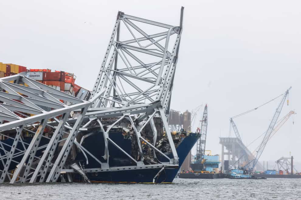 Cranes continue salvage work as wreckage of the Francis Scott Key Bridge rests on the container ship Dali (Julia Nikhinson/AP)