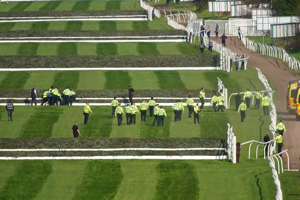 Police officers responding to Animal Rising activists attempting to invade the race course ahead of the Randox Grand National Handicap Chase 2023 (Peter Byrne/PA)