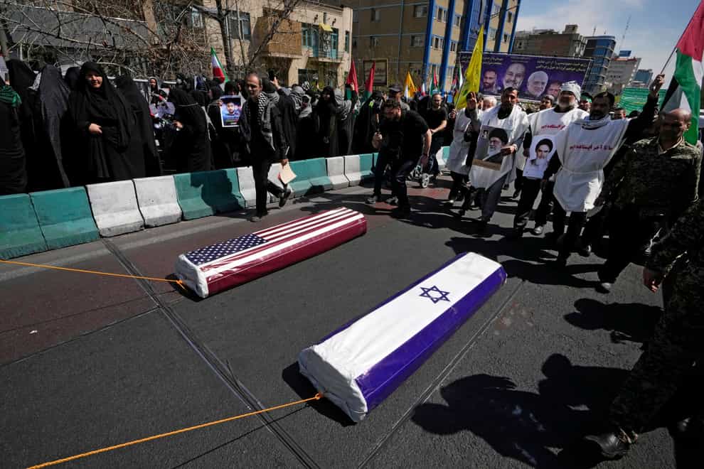 Iranians pull symbolic coffins for the US to mark Quds Day, or Jerusalem Day, in support of Palestinians, in Tehran (Vahid Salemi/AP)