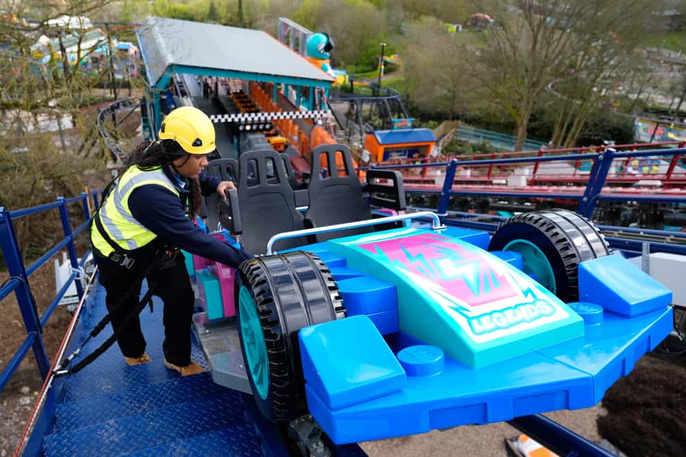 Legoland team member Shenica Gumbs inspects a car on the Minifigure Speedway, as final checks are made to the new ride at Legoland Windsor Resort, in Berkshire (Andrew Matthews/PA)