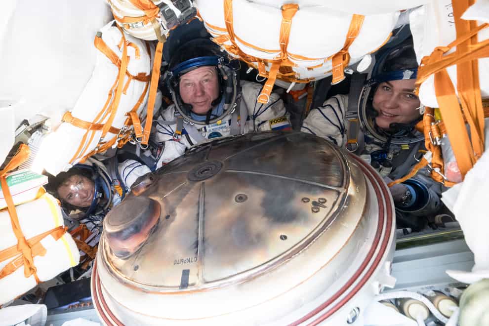 Nasa’s Loral O’Hara, left, Russia’s Oleg Novitsky and Belarus spaceflight participant Marina Vasilevskaya, right, are seen inside the Soyuz MS-24 spacecraft after they landed in a remote area in Kazakhstan (Bill Ingalls/Nasa via AP)