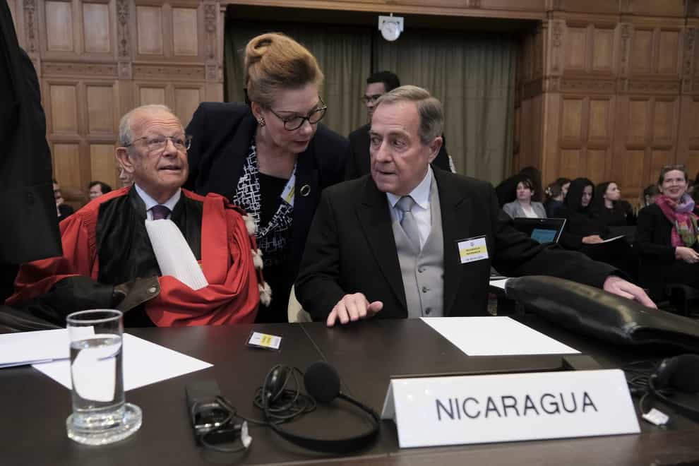 Nicaragua’s Ambassador Carlos Jose Arguello Gomez, right, and Alain Pellet, left, a lawyer representing Nicaragua, wait for the start of a two day hearing at the World Court in The Hague, Netherlands (Patrick Post/AP)