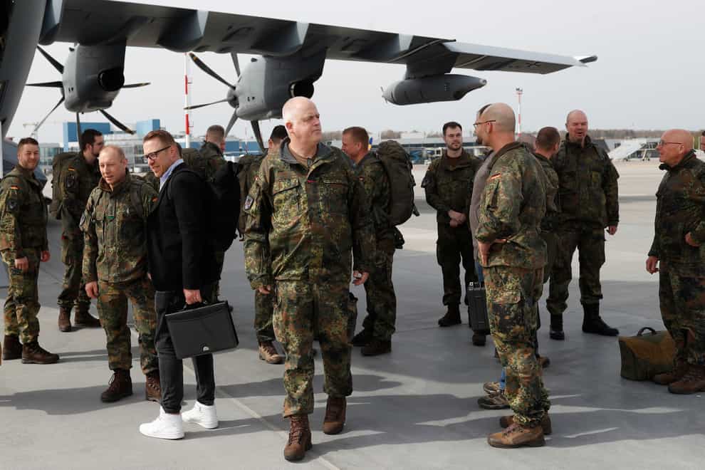 German Bundeswehr soldiers of the Headquarters initial command element of the Bundeswehr’s 45th Brigade Lithuania arrive at an airport in Vilnius, Lithuania (Mindaugas Kulbis/AP)