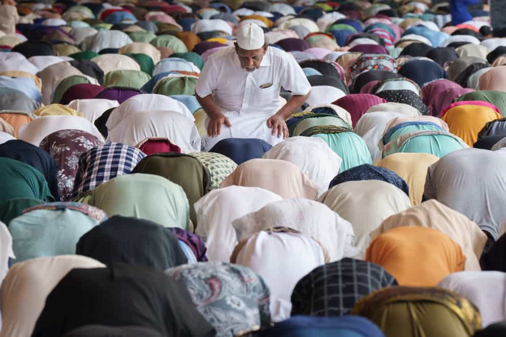 Muslims offer prayers for the Eid al-Fitr in Kuala Lumpur, Malaysia (Vincent Thian/AP)