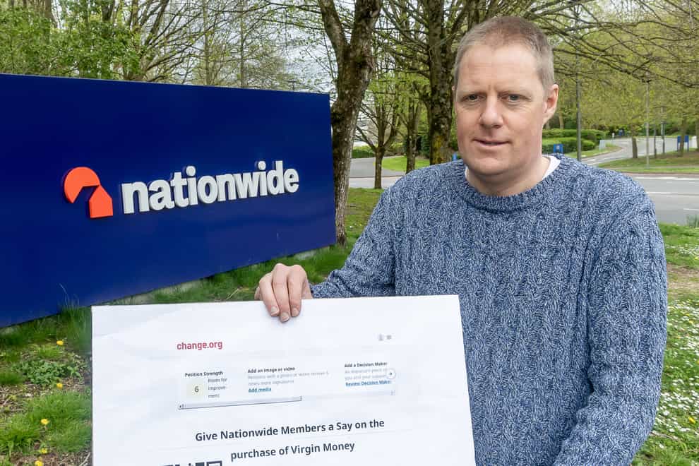 Mikael Armstrong, organiser of the Give Nationwide Members A Say campaign, outside Nationwide’s headquarters in Swindon with a petition calling for the building society to give its 16 million members a vote over its decision to buy rival lender Virgin Money (Stuart Harrison/PA)