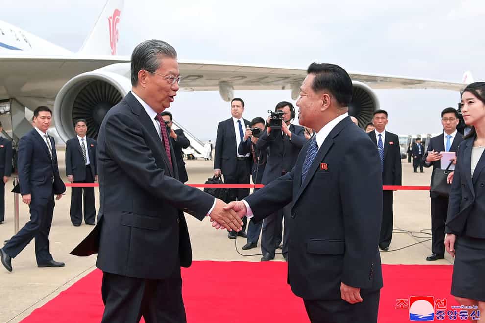 Choe Ryong Hae, front right, vice-chairman of the central committee of the Workers’ Party of North Korea, shakes hands with Zhao Leji, center left, chairman of the National People’s Congress of China (Korean Central News Agency/Korea News Service via AP)