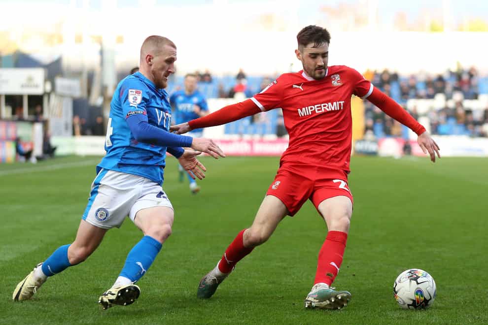 Stockport County�s Connor Lemonheigh Evans and Swindon Town�s Dawson Devoy during the Sky Bet League Two match at Edgeley Park, Stockport. Picture date: Saturday February 24, 2024.