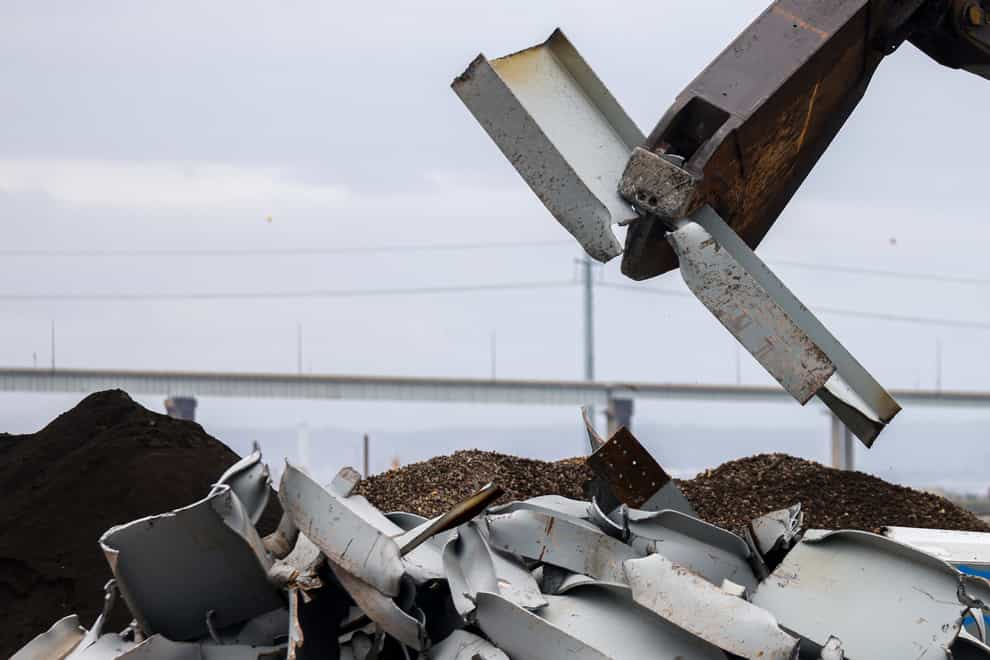 A shearer breaks apart salvaged pieces of the collapsed Francis Scott Key Bridge (AP)