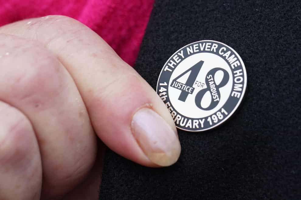 A family member touches her Stardust lapel pin on gher way into Dublin Coroner’s Court where the coroner in the Stardust inquest is due to charge the jury. Picture date: Thursday March 28, 2024.