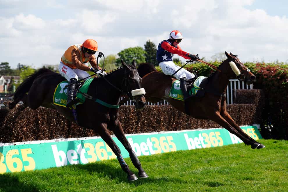 Kitty’s Light ridden by jockey Jack Tudor (right) clear a fence on their way to winning the bet365 Gold Cup Handicap Chase at Sandown Park Racecourse (David Davies/PA)