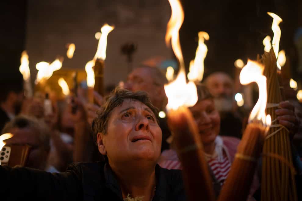 A Christian Orthodox pilgrim holds a candle during the Holy Fire ceremony (AP)