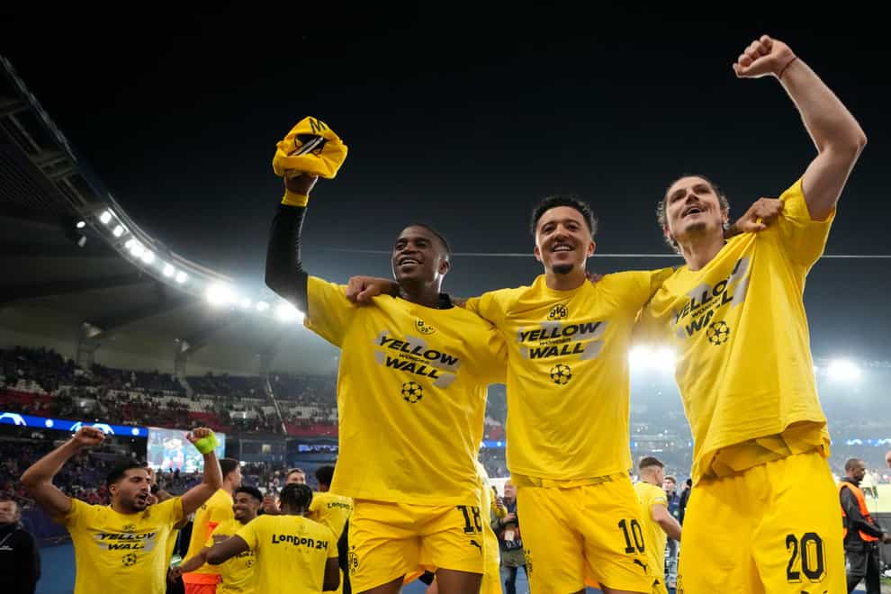 Marcel Sabitzer, right, Jadon Sancho, centre, and Youssoufa Moukoko celebrate Dortmund’s triumph (Frank Augstein/AP)