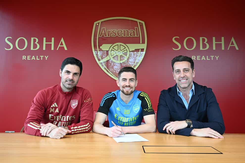 Jorginho (centre) signs his new Arsenal contract alongside manager Mikel Arteta (left) and technical director Edu (Stuart MacFarlane/Arsenal FC)
